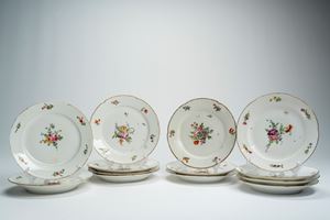 Dodici piatti piani in porcellana a bordo mosso e dorato decorati in policromia a mazzetto e fiori sparsi. Francia, fine secolo XVIII