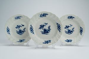 Three porcelain plates with shaped and ribbed molded rim, decorated with oriental-style cobalt-blue floral motifs. Possibly Belgium, Tournai, second half of the 18th century
