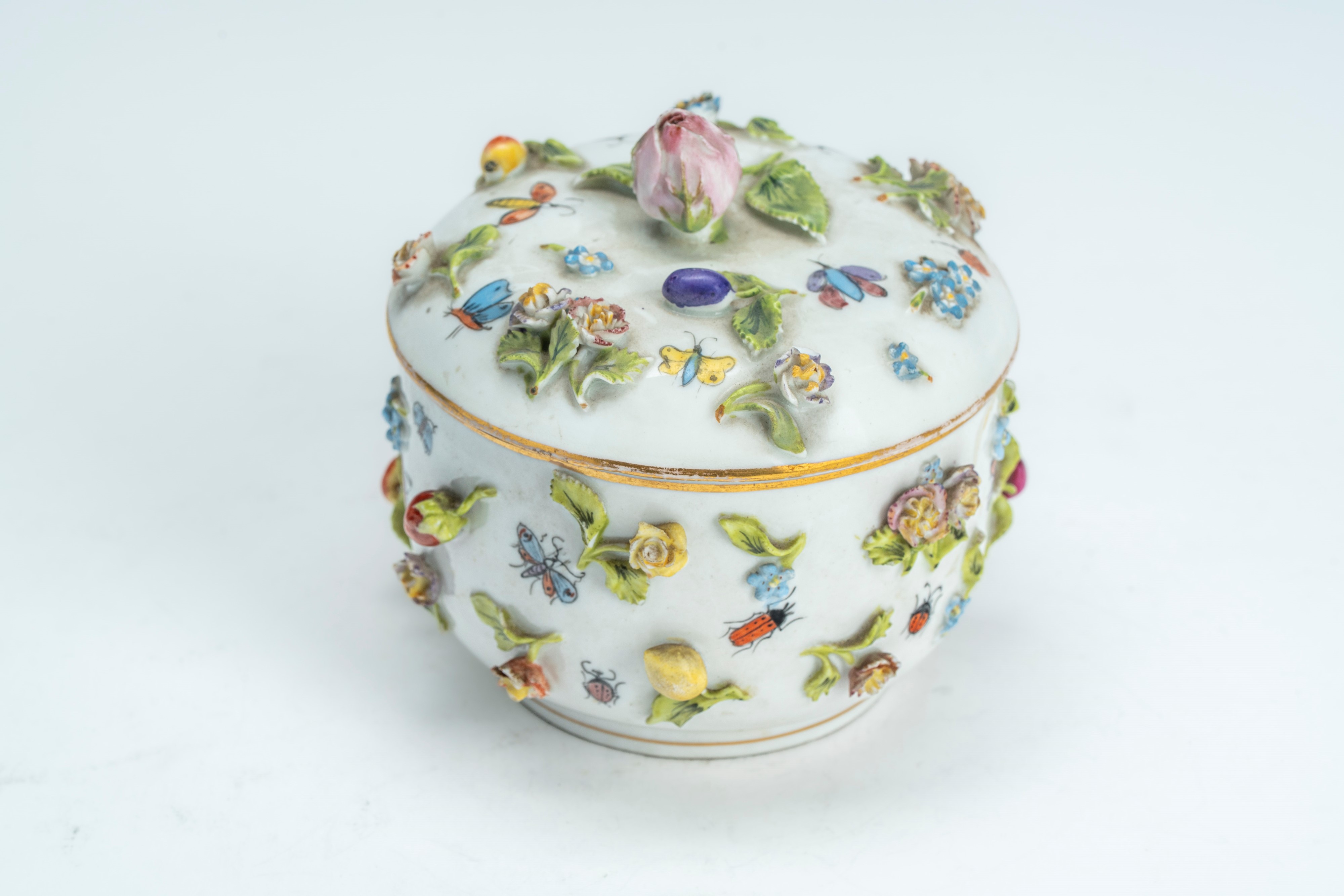 Porcelain box and cover decorated in polychrome with painted and relief ...