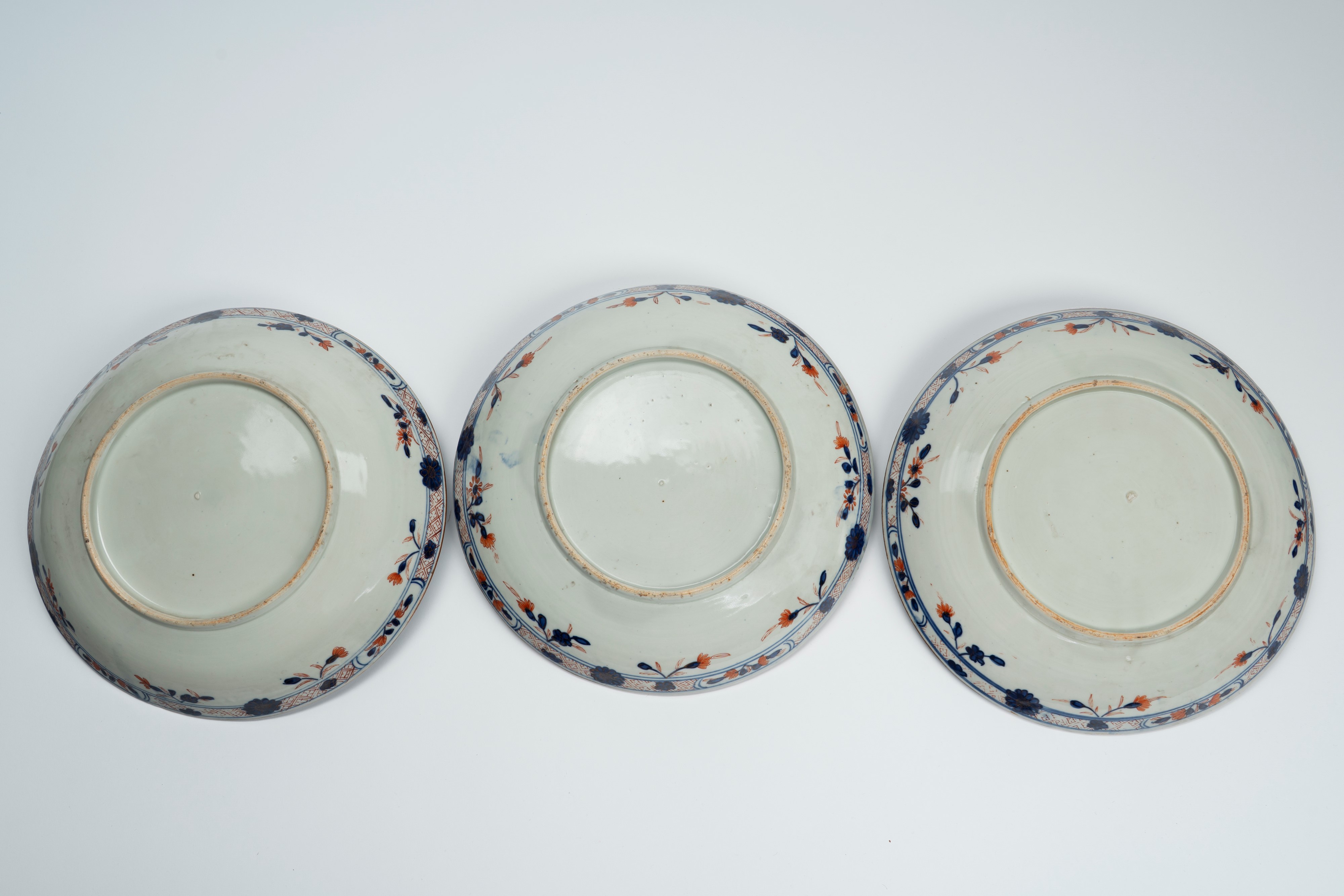 Tre piatti in porcellana con invetriatura powder blue e decori dorati. Cina, secolo XVIII/XIX