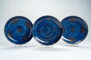 Tre piatti in porcellana con invetriatura powder blue e decori dorati. Cina, secolo XVIII/XIX