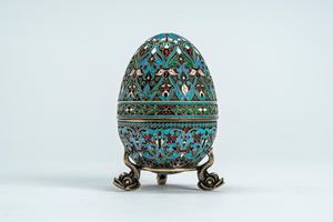 Gilt silver egg with polychrome cloisonné enamels of stylized vegetal motifs, on a detachable tripod stand chased with dolphins. Moscow, approximately 1898–1914