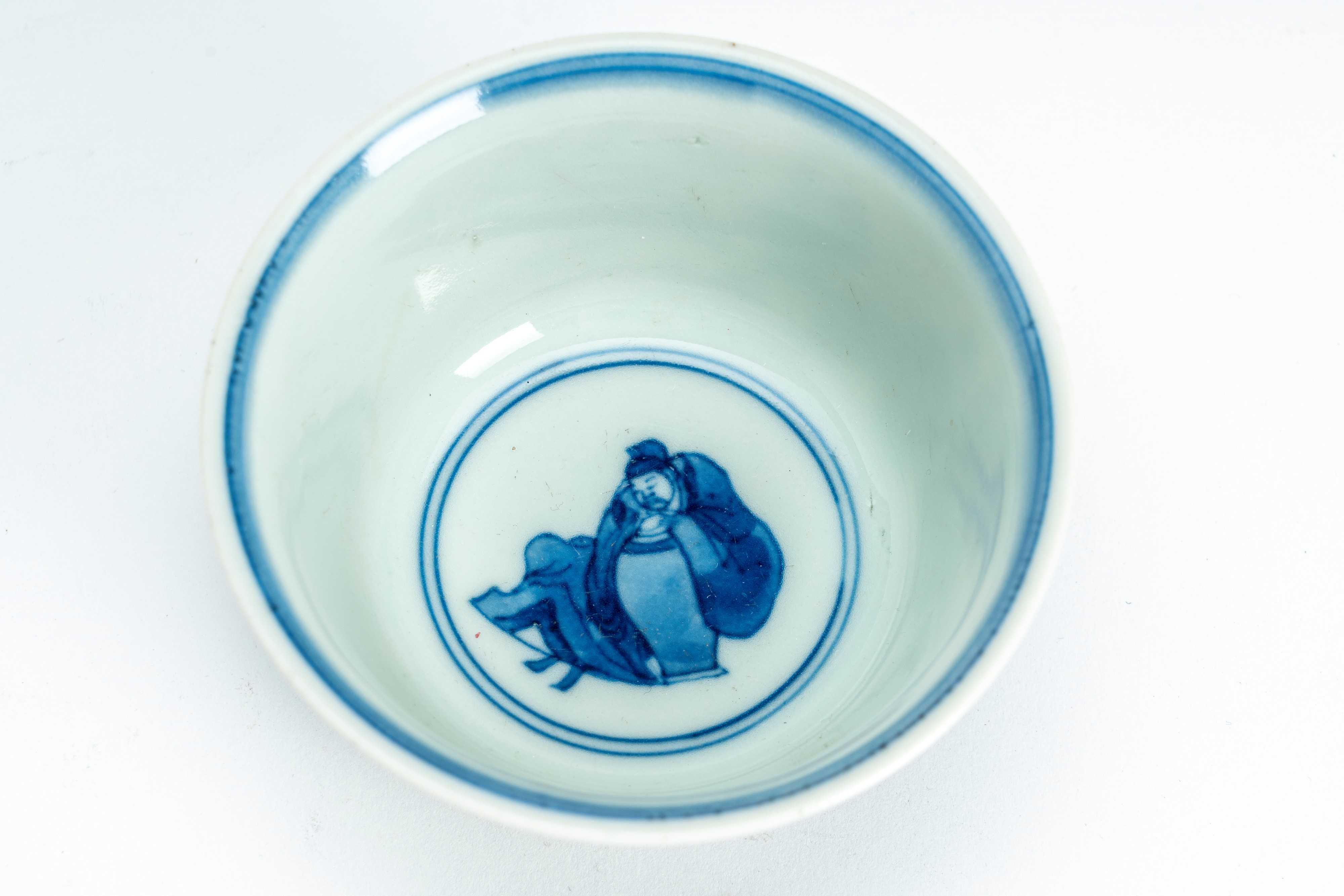 Ciotolina in porcellana bianca e blu decorata con figure in un giardino. Cina, periodo della Repu...