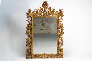 Large antique mirror with richly carved foliate frame, the cresting centered by a vase with flowers and fruit