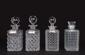 Lotto composto da quattro bottiglie in cristallo, tre con etichetta in argento