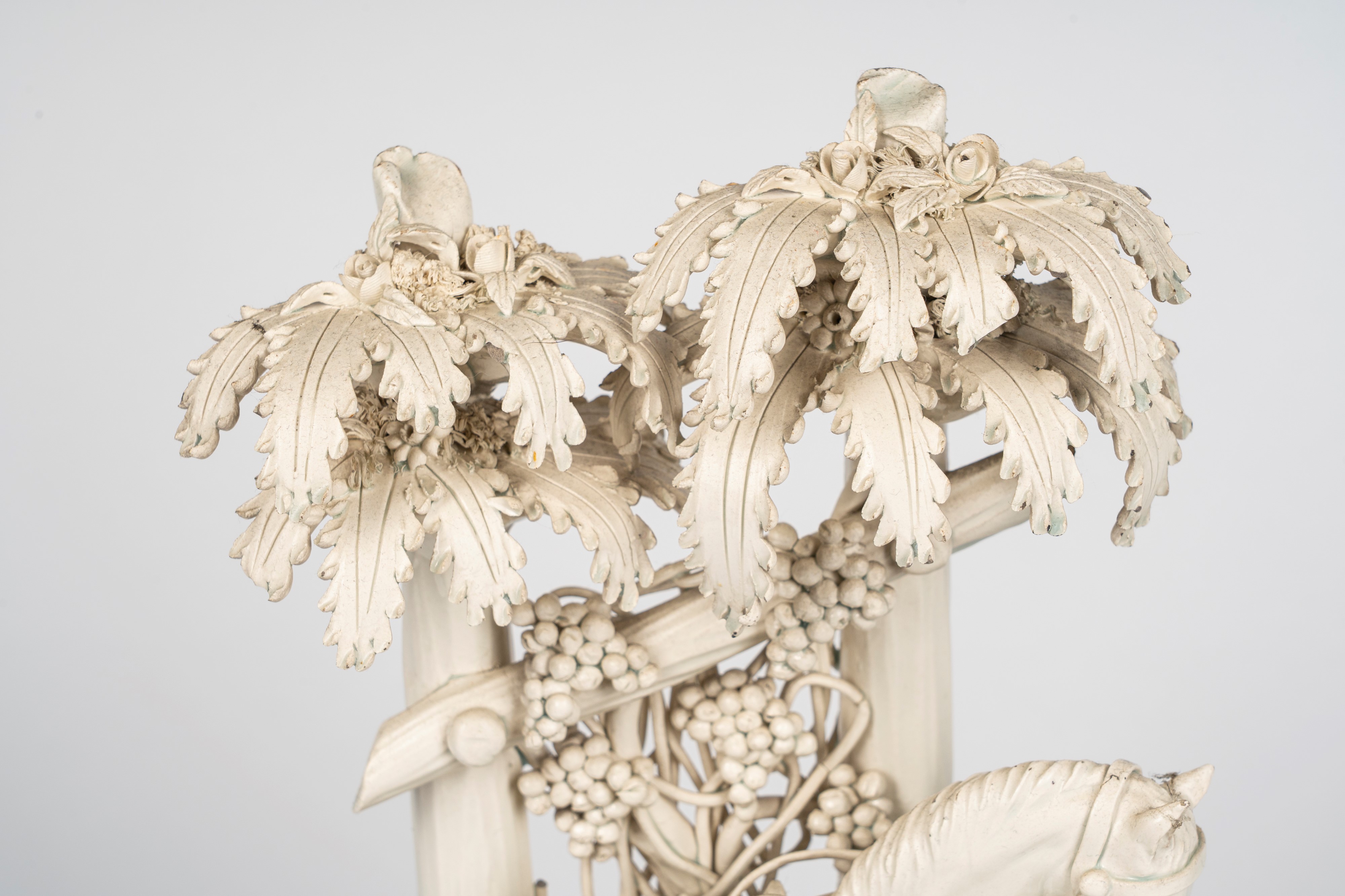 Gruppo in terraglia smaltata bianca raffigurante scena galante in un giardino con cavallo e giova...