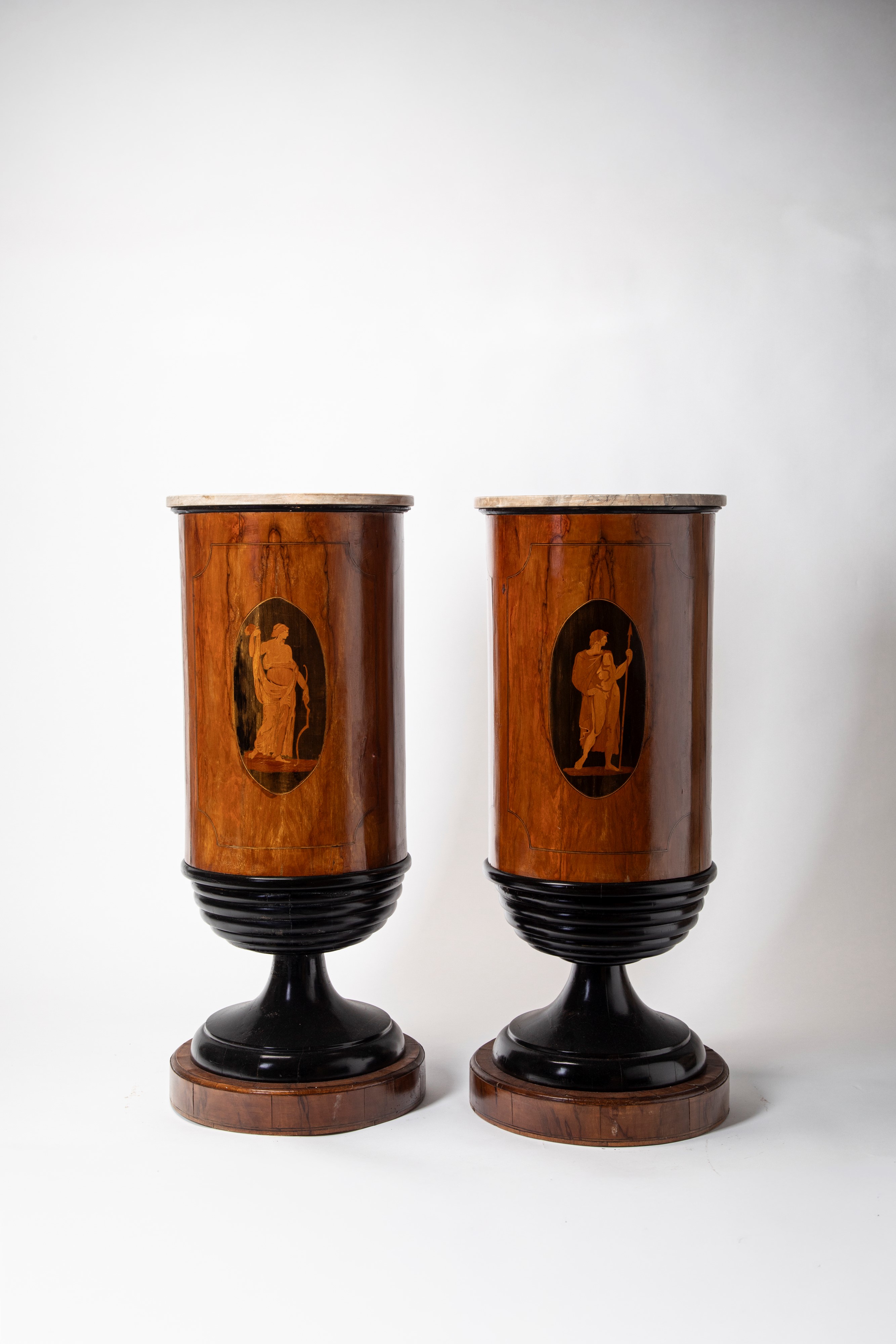 Coppia di gueridon a cilindro in legno lastronato e intarsiato con piani in marmo. Fine secolo XV...