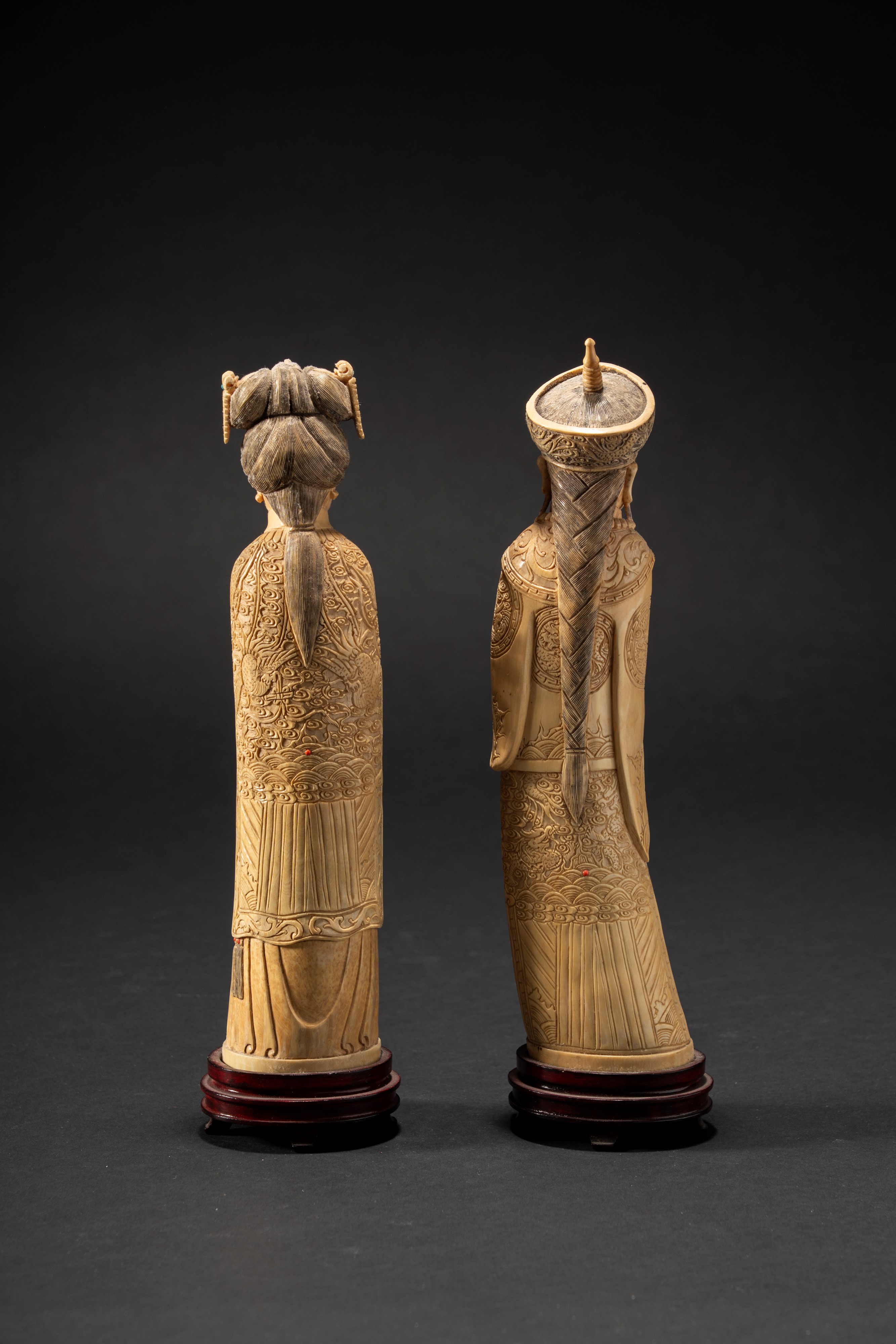 Coppia di dignitari in avorio abbelliti con piccoli castoni rossi e turchesi, Cina, tarda dinasti...