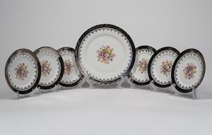 A porcelain dessert set consisting of six saucers and a serving platter. Bavaria, 20th century.