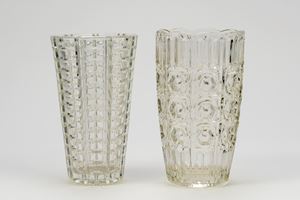 Two clear ribbed glass flower vases decorated with geometric motifs