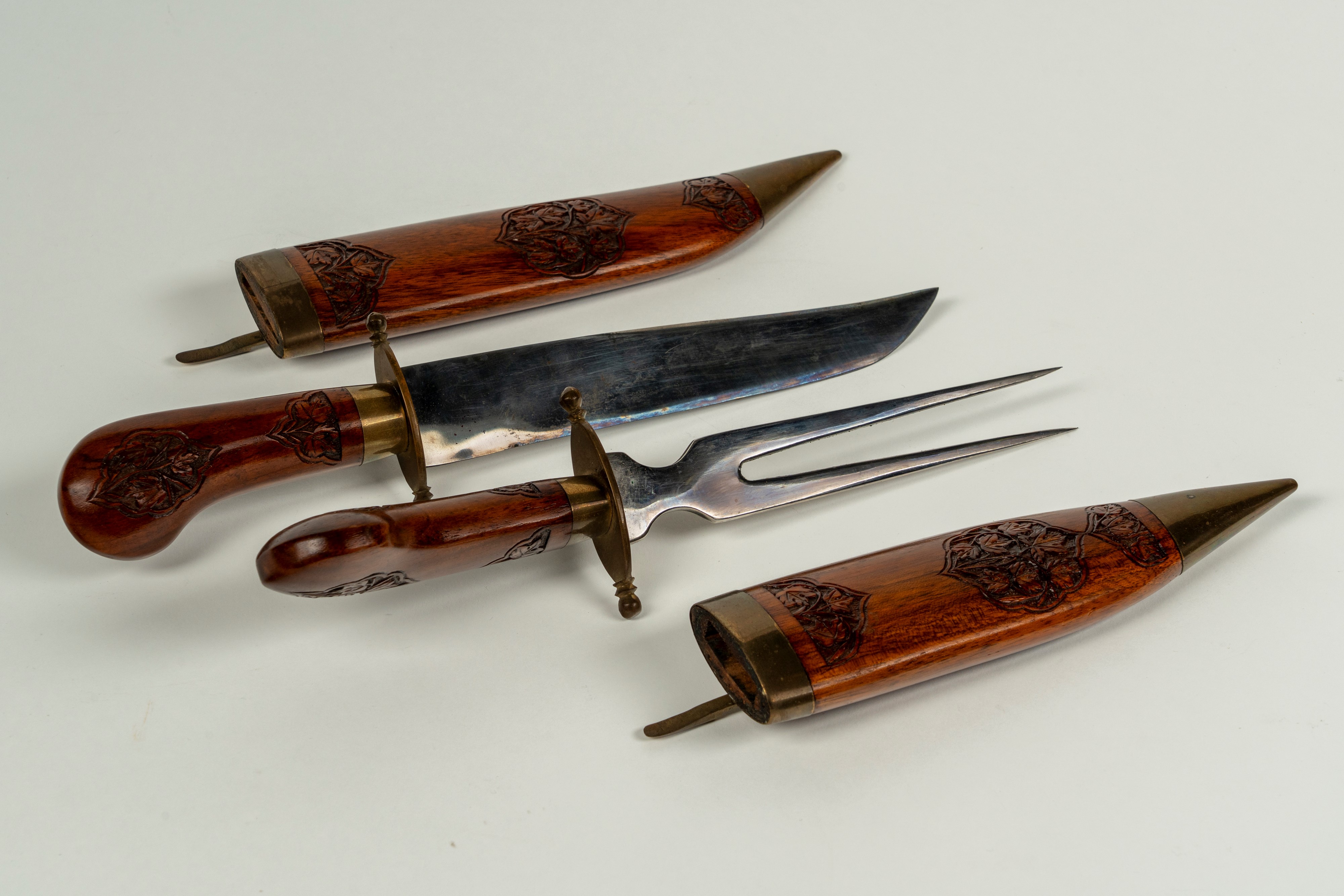 Set da arrosto composto da forchettone e coltello in custodia a forma di pugnali in legno inciso ...