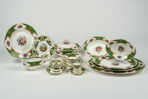 Porcelain service decorated in polychrome with floral motifs, birds, reserves, and green borders with gilding. Coalport, Broadway Green, 20th century.