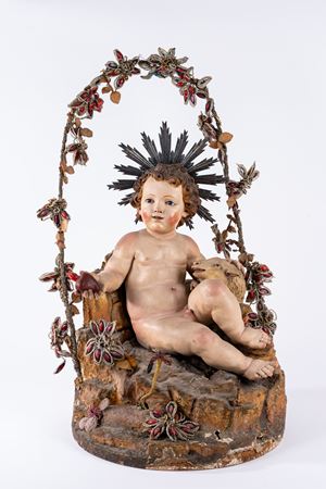 Ges&ugrave; bambino seduto su base rocciosa con agnello  accovacciato in terracotta e cartapesta policroma. Italia meridionale, secolo XVIII (h cm 45 circa)