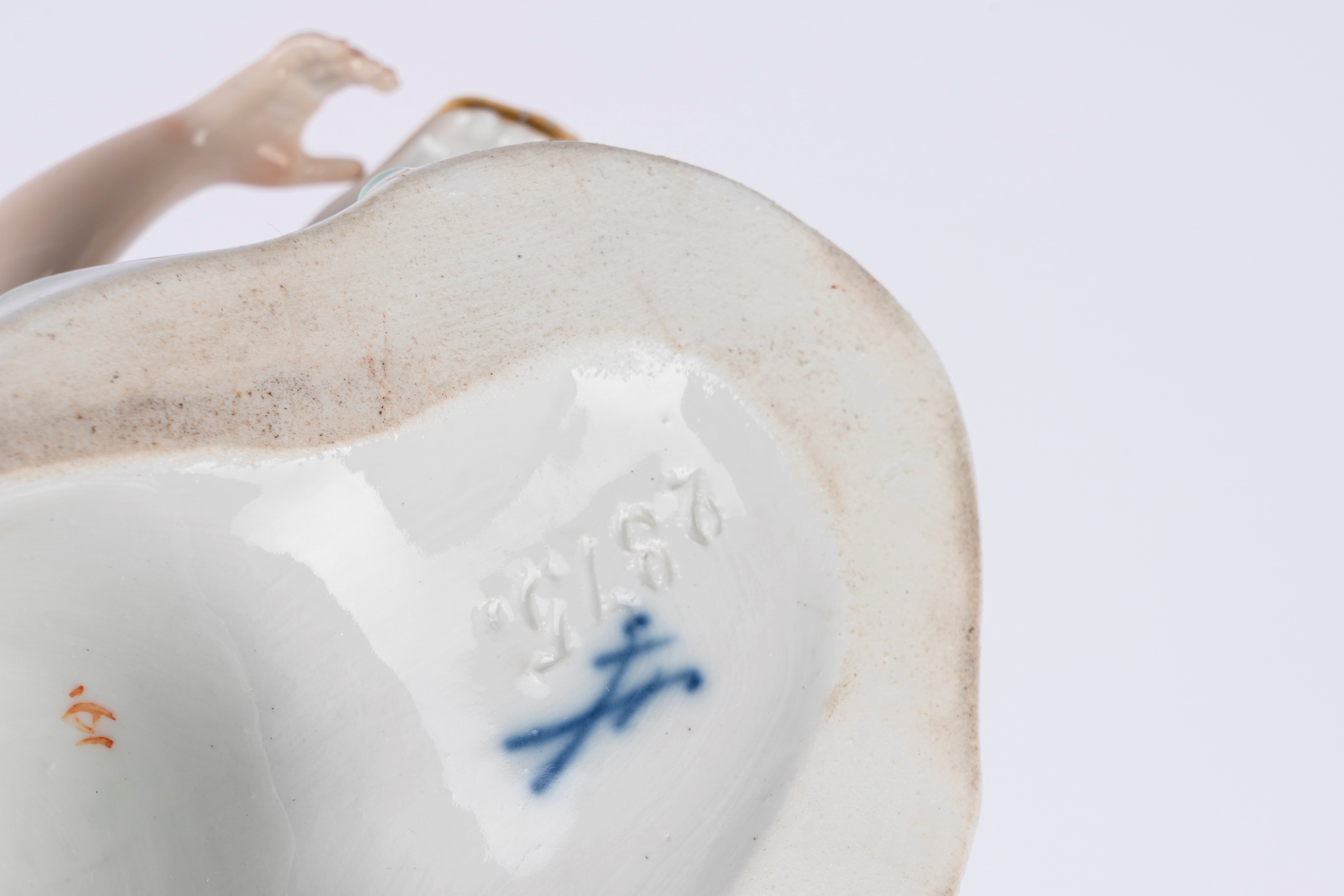 Coppia di saliere o salsiere in porcellana policroma in forma di fanciulla sdraiata che sostiene ...