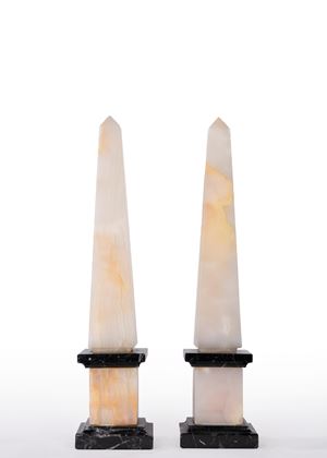Pair of alabaster and black marble obelisks. 19th-20th century.