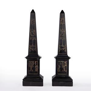 Pair of black marble obelisks decorated with bas-reliefs of Egyptian motifs