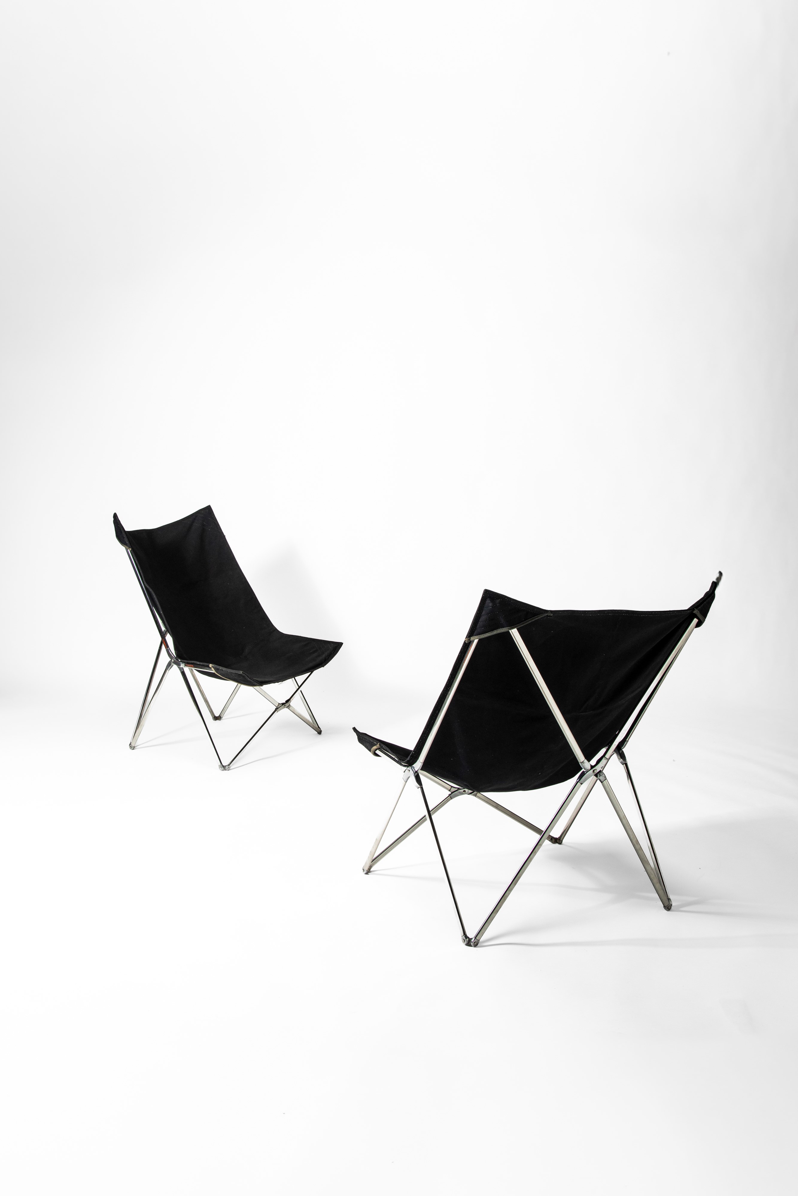 Gae Aulenti - Coppia di tripoline modello n. 835(920) “April”, acciaio inox, alluminio e tessuto
