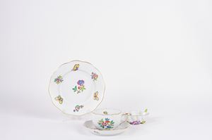 Set consisting of a teacup and saucer, a dessert plate and a leaf-shaped porcelain saucer, decorated with flowers and butterflies, Herend