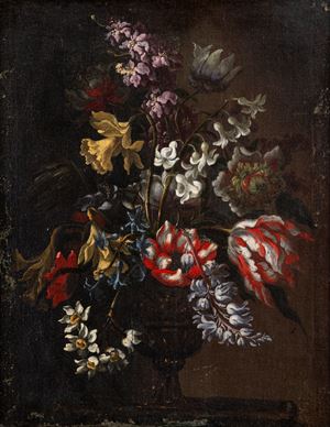 Tulips, daffodils, jonquils and hyacinths in a decorated vase on a table