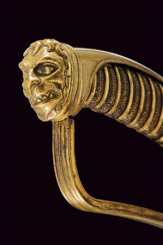 Rara sciabola da ufficiale di cavalleria, lama incisa e dorata, bronzo e legno rivestiti in pelle...