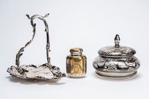 Lot comprising a glass biscuit bowl with silver decorations and a silver-plated metal fruit bowl in the shape of a stylized leaf and branch. Mid-20th century.