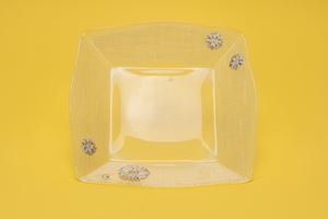 Clear glass bread basket with silver foil daisy inserts.