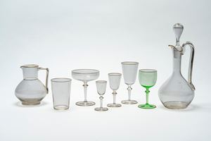 Crystal glass set with gold profiles and engraved crowned monogram.