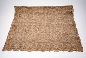 Rectangular Burano lace tablecloth with rich floral motifs on a mesh background. Includes twelve napkins.