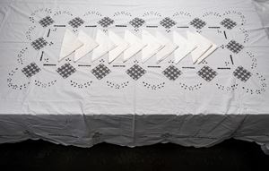 Rectangular tablecloth with ten matching white linen napkins.