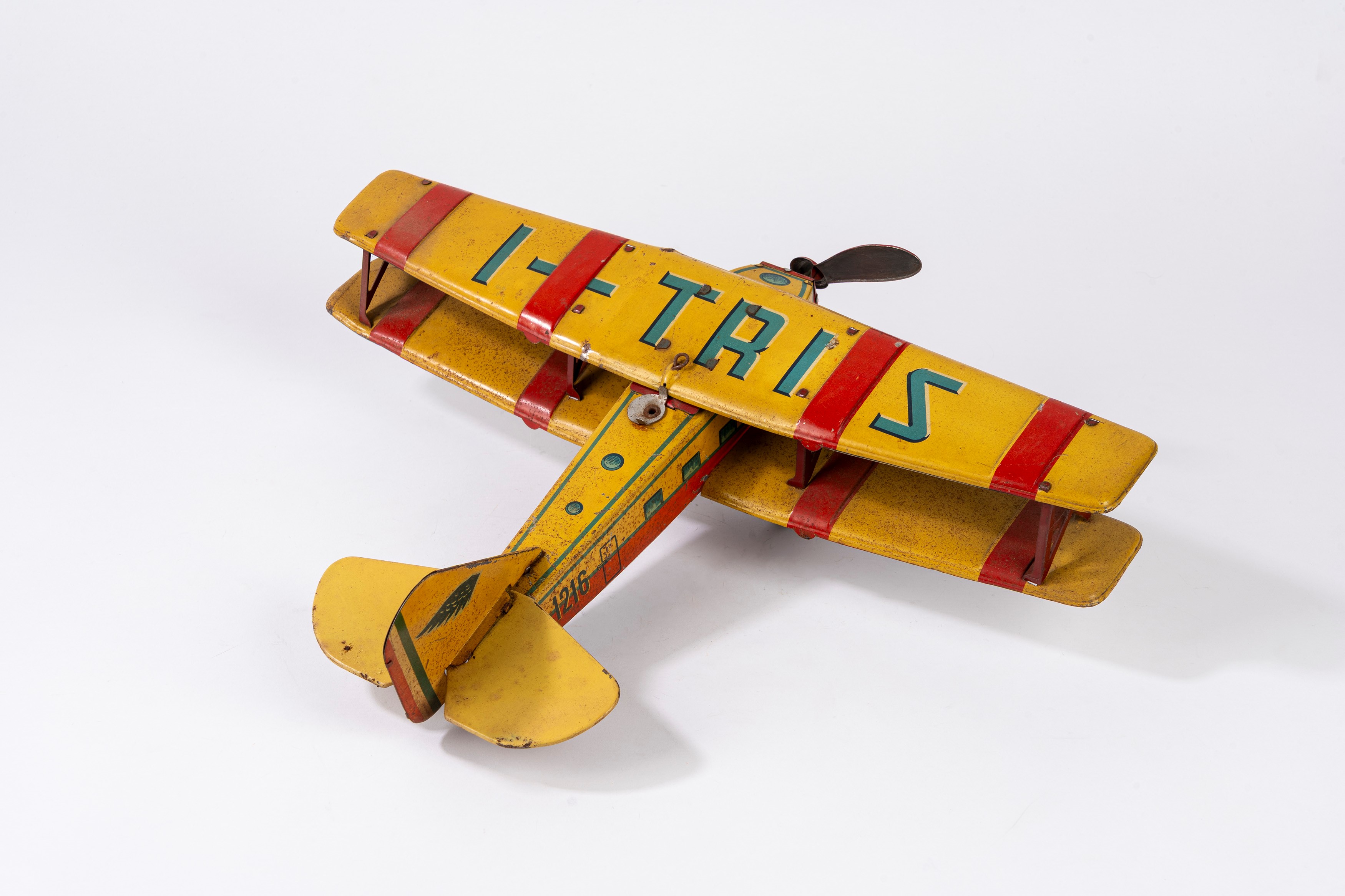 Ingap - Aereo I-TRIS 1206, latta litografata biplano con elica centrale e carica a molla (anni 19...