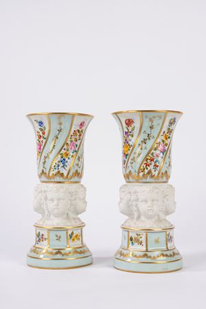 Pair of porcelain vases with biscuit cherub heads