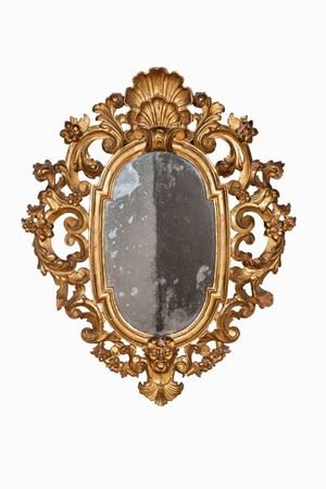 Manifattura italiana, secolo XVIII  - Due specchiere in legno intagliato e dorato con motivi a volute floreali, mascherone e cimasa a forma di conchiglia