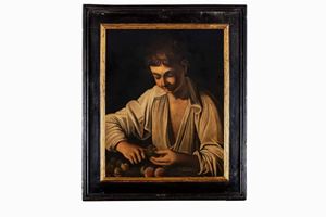 Boy peeling a fruit