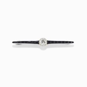 A platinum, onyx and diamond brooch, early 20th Century