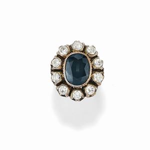 A silver, 18K yellow gold, sapphire and diamond ring