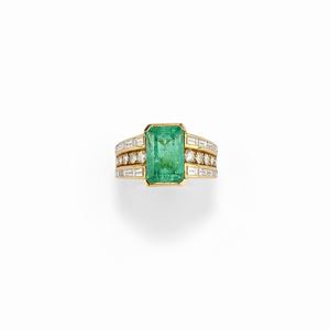 A 18K yellow gold, emerald and diamond ring