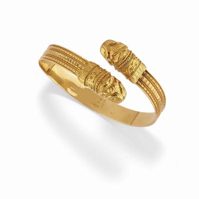 Bracciale rigido in oro giallo 18K con terminali a teste di leone