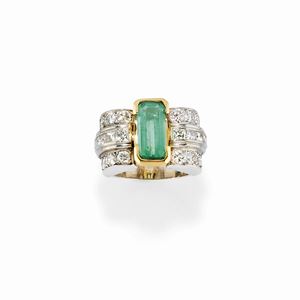 A platinum, 18K yellow gold, emerald and diamond ring