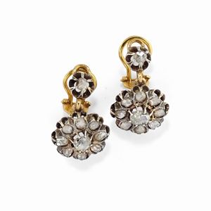 A silver, 18K yellow gold and diamond earclips, early 20th Century