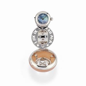A 18K white gold, quartz, mother of pearl and diamonds ring with watch.