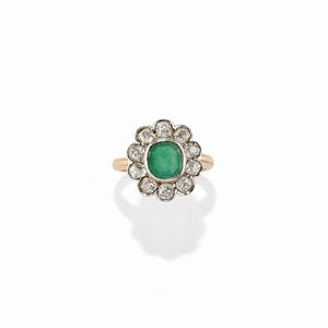 A silver, 18K yellow gold, emerald and diamond ring
