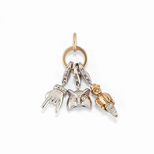  - A 18K red and white gold and diamond pendant whith three charms