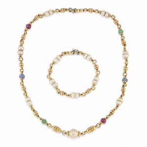 A 18K yellow gold, cultured pearl, ruby, sapphire and emeral demi parure, necklace and bracelet