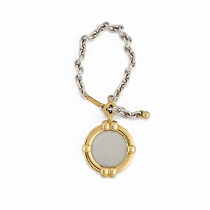 Chopard - A 18K yellow gold and steel keychain, signed and numbered Chopard