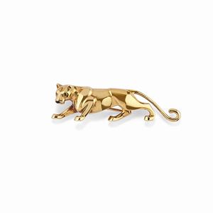 A 18K yellow gold, onyx and emerald brooch, Cartier