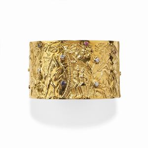 A 18K yellow gold, sapphire, ruby and diamond bangle