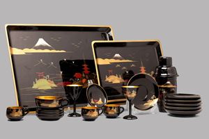 Service consisting of six teacups with saucers, six small goblets and a shaker, four smaller cups with saucers, ten teaspoons and two trays, in black and gold lacquer, Japan 20th century