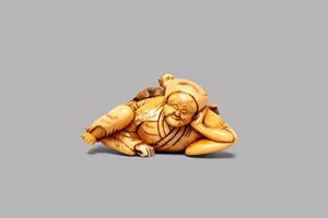 Ivory netsuke depicting a lying man with a monkey, Japan, Edo period, 18th-19th centuries