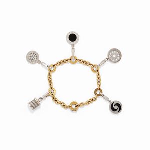 A two color gold, diamond and onyx bracelet with charms, Bulgari
