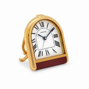 A golden brass alarm clock with original box and warranty, circa 1990, Cartier
